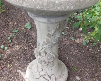 Concrete birdbath with rose motif.