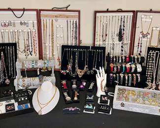 Large assortment of vintage costume jewelry and watches. Lots of new old stock Avon