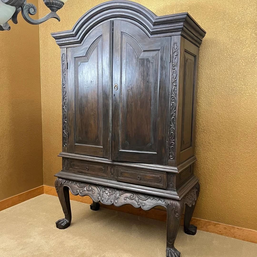 Antique Dutch Colonial Bonnet Top Mahogany Storage Cabinet w/ Ornate Carvings. Two Lower Drawers and Apron