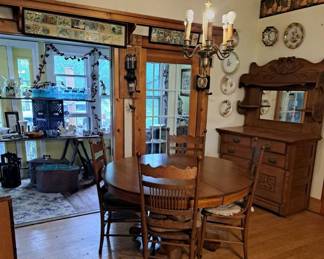 Oak table pulled out can sit 12 has 4 chairs. Hutch