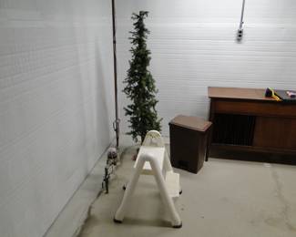 A stool and a skinny tree