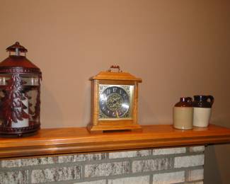 Lantern, clock, and two small pottery jugs, going left to right. If you went right to left it would read, pottery jugs, clock, and lantern