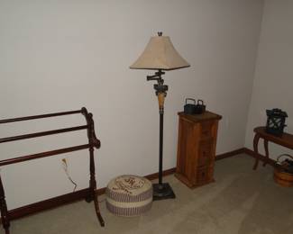 Foot poof, to rest your weary feet, nice floor lamp, and three drawer cabinet