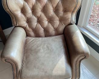 Opulence Home tan leather recliner with studded trim. 