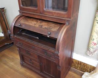 Victorian Cylinder Secretary desk 19th century roll top cabinet with glass shelves and enclosure above . 