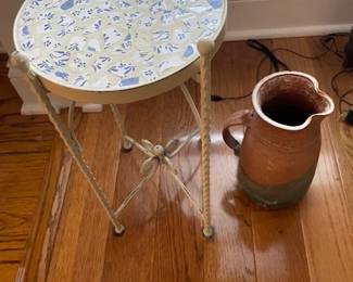 Round ceramic table and ceramic vase.