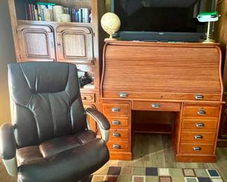 Leather desk chair 65” Seiki TV. Oak roll top desk 