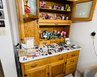 Antique Hoosier Cabinet with Local Advertising pieces on it. 