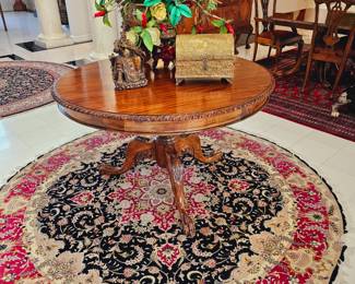 Pakistanian round rug with claw footed round table. 