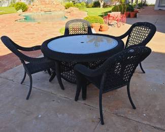 Black wicker looking rope patio set. Has some damage to the top of one chair. Granite topped.