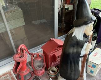 The "witch" is guarding the vintage lantern, water pump, and fire call box.  I think if you ask nicely, she'll let you see them.