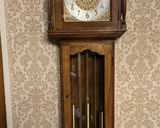 This is a fine example of a grandfather clock, sure to enhance any decor.