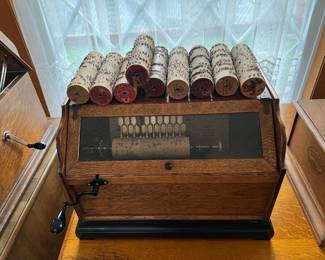 This particular piece is quite unique, although I'm sure there are more than a few out in the real world.  This is a vintage, hand-cranked, cylinder-format music box.  