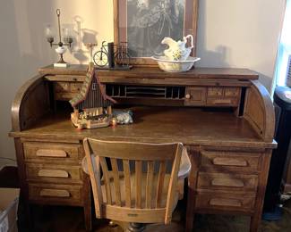 There are other items besides the vintage music players, like this roll-top desk and wooden office chair.  A rather fetching framed painting of a woman and her bicycle sits on top.  There is also a small model house, a pitcher and wash basin, a bicycle bookend set, and a lamp without a shade.
