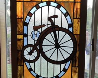 Here you can see another example of the bicycle theme in the house.  In this case, the stained glass shows a pennyfarthing.