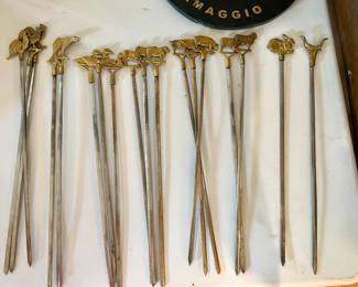 Metal meat skewers with animals on the end 