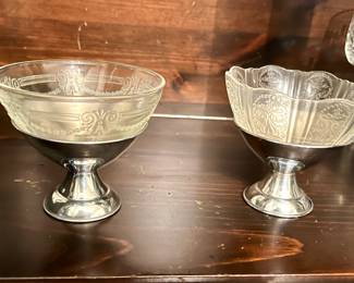 Unique, etched glass champagne glasses.  The glass lifts out of the metal cup