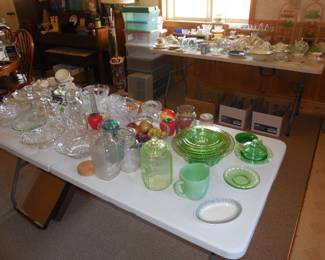 green glassware, many glass candlesticks in boxes under table