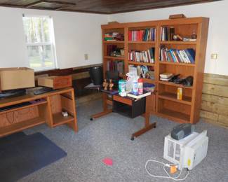 Air conditioner, bookshelves, desk, books.