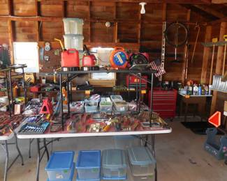 Tons of tools in like new condition. Unicycle hanging in background. Lots of storage totes too.