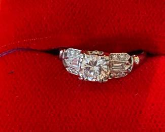 Outstanding platinum ring with half carat diamond center stone surrounded by baguettes and small brilliant cut stones