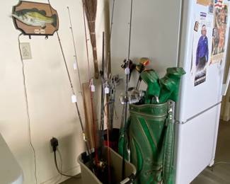 Fishing poles and clean Amana refrigerator for extra storage