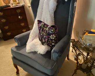 Blue wingback chair with another Vera Bradley purse and a vintage hat
