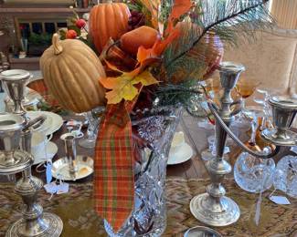 Beautiful large cut glass vase with fall foliage.  Sterling candelabra on either side