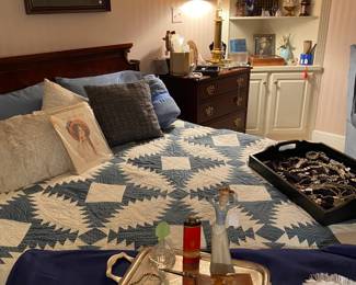 A view of the bedroom with tray of jewelry and interesting collectibles in the background.