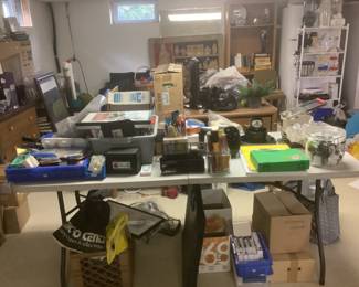 Table of office supplies paper pens etc