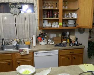 Kitchen is very full. Several sets of dishes.