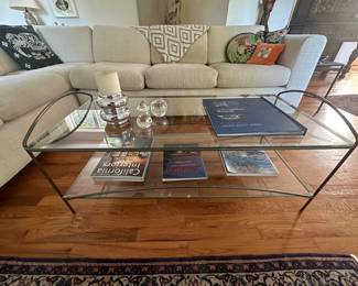 Iron and glass Coffee Table, Books, Crystal, Throw Pillows on a White Chenille Tuxedo Sofa Sectional