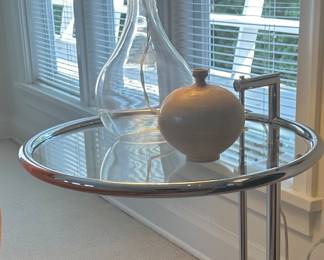 Iconic, E1027 "style" Side Table designed by Eileen Grey, holds a Glass Table Lamp With Linen Shade, and Earthenware Weed Pot