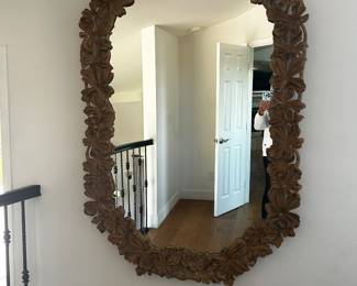 This is a large hand carved mirror.