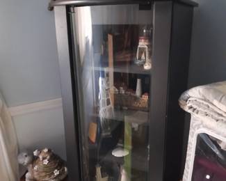 Curio cabinet filled with nautical items