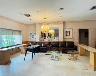 2 leather sofas and 2 sofa tables ,custom lucite and glass cocktail table and crystal chandelier