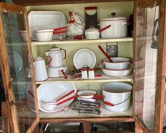 Old wooden cupboard 
Collection of red & white enamelware 