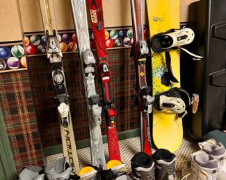 assortment of snow board boots and skis and snow boards, just in time for the season
