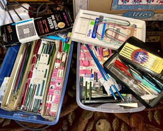 lots of knitting and crochet hooks in varying sizes