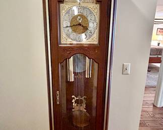 Lot #51 - $250-Howard Miller Grandfather clock. Not keeping time, but has all 3 weights and pendulum. Missing side panel at top. serial #338927.