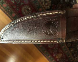 CLOSE UP VIEW OF MARBLES ORIGINAL SHEATH WITH FLYING DUCKS STAMPED MARBLES ON REVERSE.  RARE MARBLES ORIGINAL STAGKNIFE IN ITS ORIGINAL SIGNED MANUFACTURED LEATHER SHEATH.  VERY RARE SOUGHT AFTER HUNTING KNIFE.