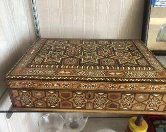 CLOSE UP VIEW OF AN ORNATE INLAID CIGAR BOX OF IVORY AND OTHER RARE EXOTIC WOODS.  IN OVERALL EXCELLENT SHAPE FOR ITS AGE.