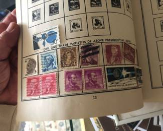 CLOSE UP VIEW OF A PAGE OF COLLECTED STAMPS FROM A VERY THICK BOOK PURCHASED AT THE JL HUDSON STORE IN DOWNTOWN DETROIT.