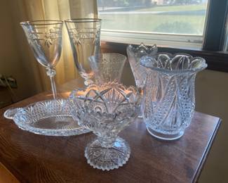 Samples from the large collection of crystal stemware and cut glass. Full set of wine and water crystal stemware rimmed with gold. Vases, serving dishes, platters and cut glass bowls available. Photo is just a selection.