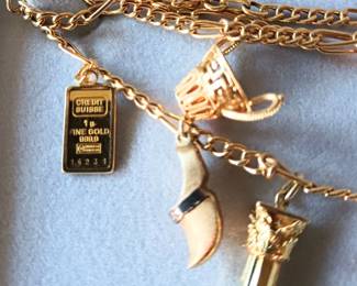 European Gold. Gorgeous and unique gold charm necklace. Charm in left is 24k gold, other charms are 14k. The necklace chain is 18k gold. 22.30g