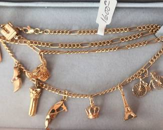 18k Gold Chain, Eight 14k Gold Charms, One 24k Gold Charm, Necklace.