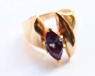 I couldn't get a good photo of this amazing ring. The stone is mesmerizing! It looks like a deep blue sapphire but when it catches the light there appears fiery flecks of red a d purple. 14k gold.