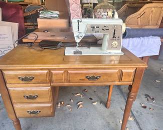 Table with Singer sewing machine up. 