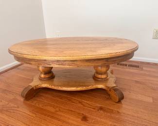 Oval oak pedestal coffee table. 
