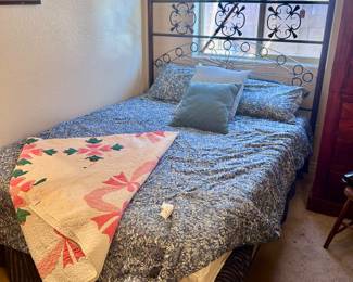 Metal framed queen sized bed and headboard with mattress and bedding set
